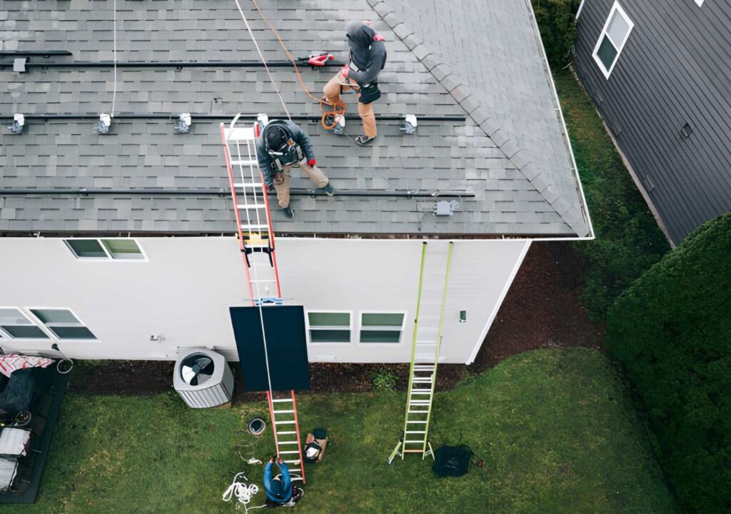 Aerial View of Solar Energy Technicians Working To Install Solar Panels