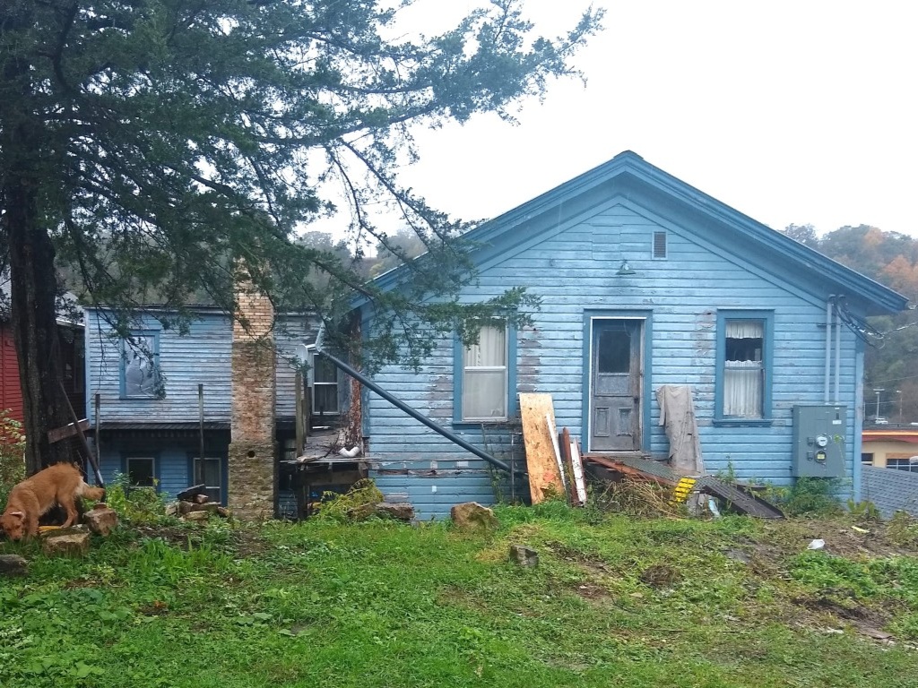 blue-hotel-lanesboro-mn-before-rear-elevation-old-siding-windows.jpg (1)
